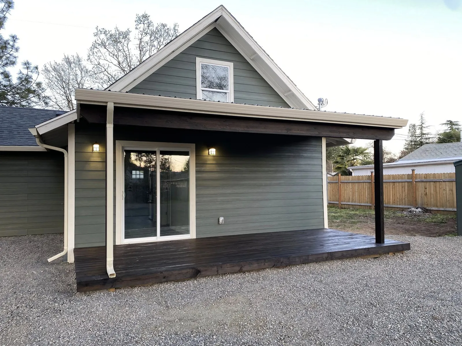 Home with sage-green lap siding, cream trim, and a covered porch in the Jacksonville, Oregon area served by Next Gen Contracting