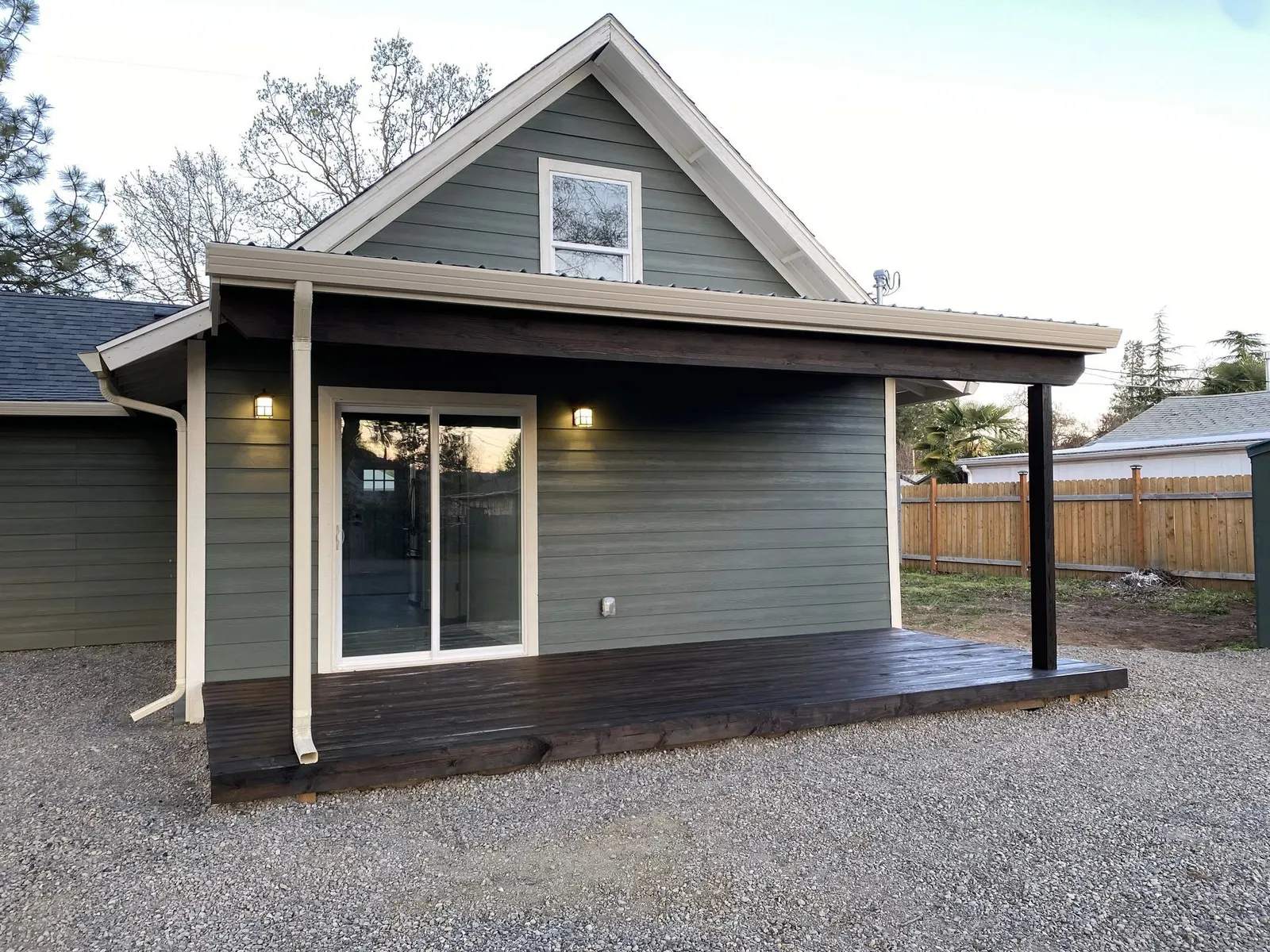 Home with sage-green lap siding, cream trim, and a covered porch in the Rogue River, Oregon area served by Next Gen Contracting