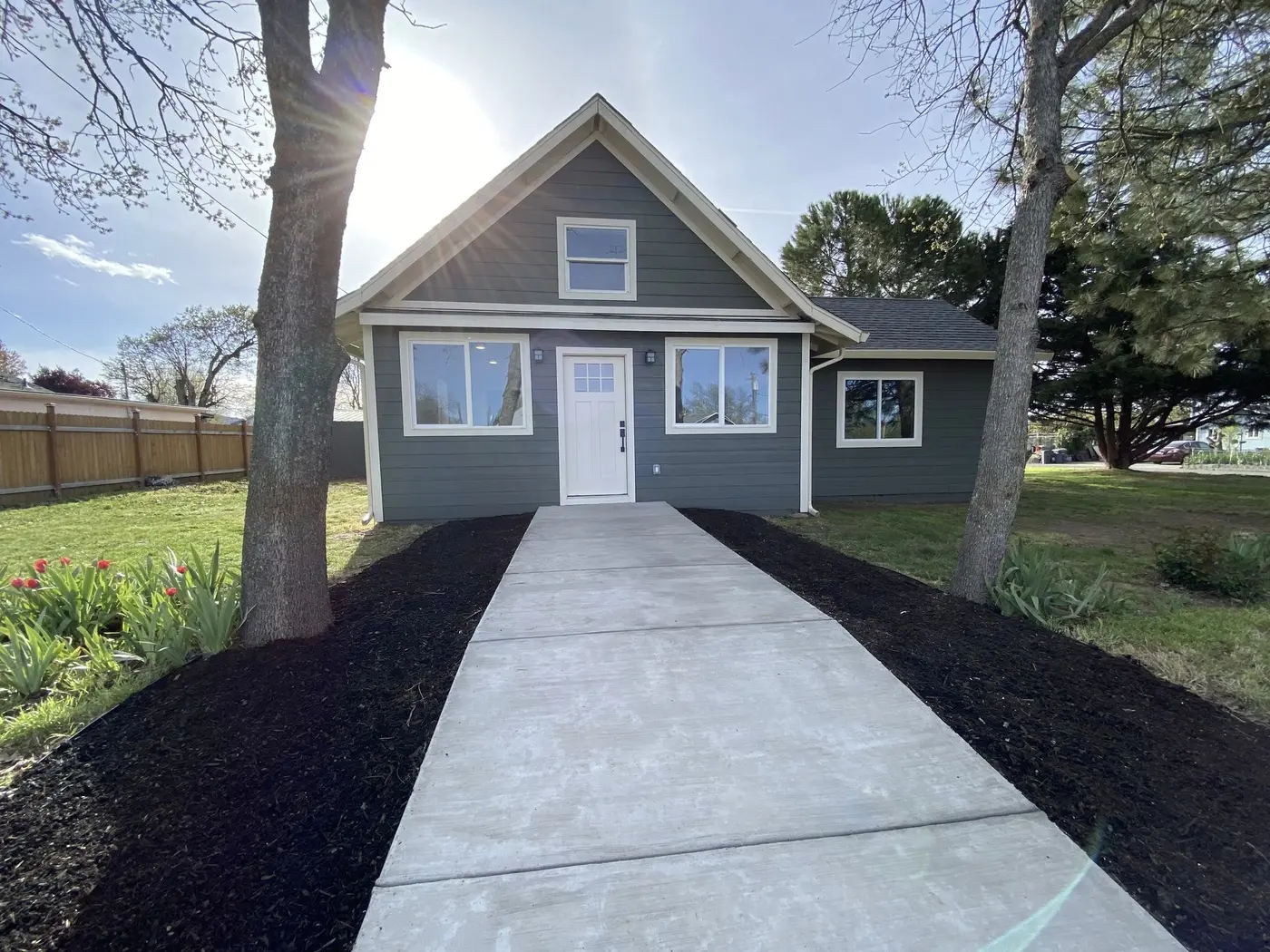 Finished single-story home with green lap siding and white trim, siding project by Next Gen Contracting in Southern Oregon