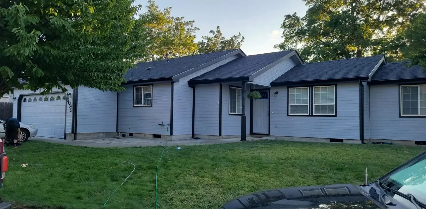 Single-story ranch home with light gray siding and a two-car garage, exterior work by Next Gen Contracting in Southern Oregon