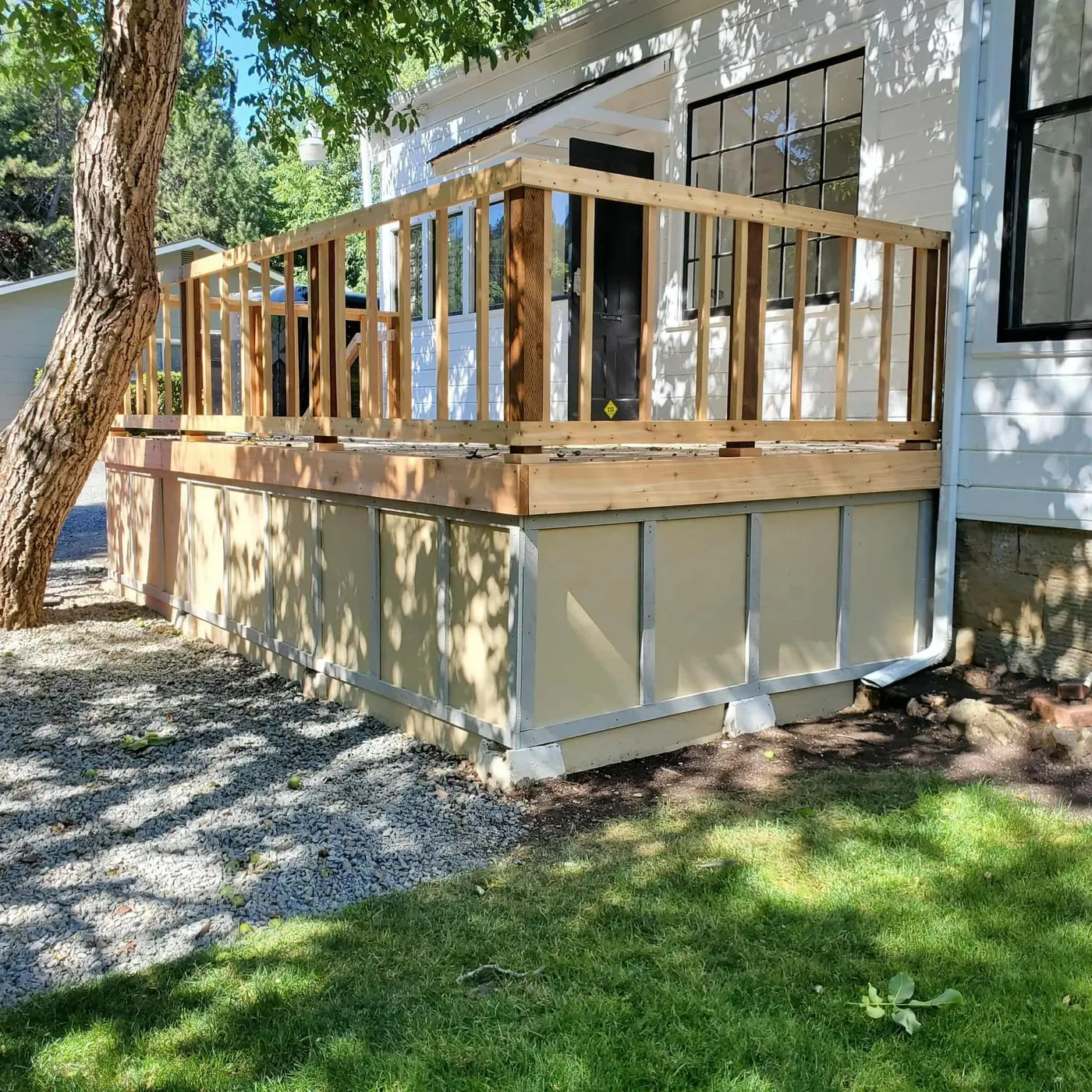 Newly built raised wood deck on a white-sided home by Next Gen Contracting in Southern Oregon